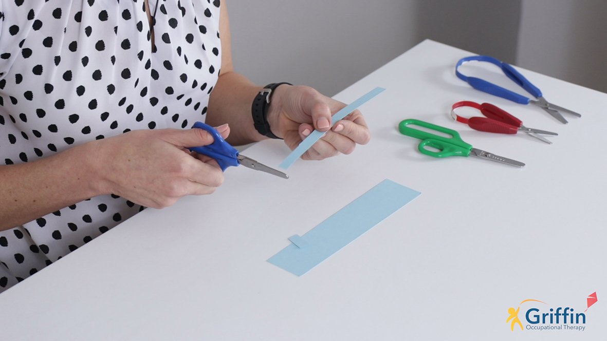 demonstrating using scissors with thumbs facing the ceiling