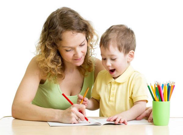 teacher helping student write and supporting pencil grasp